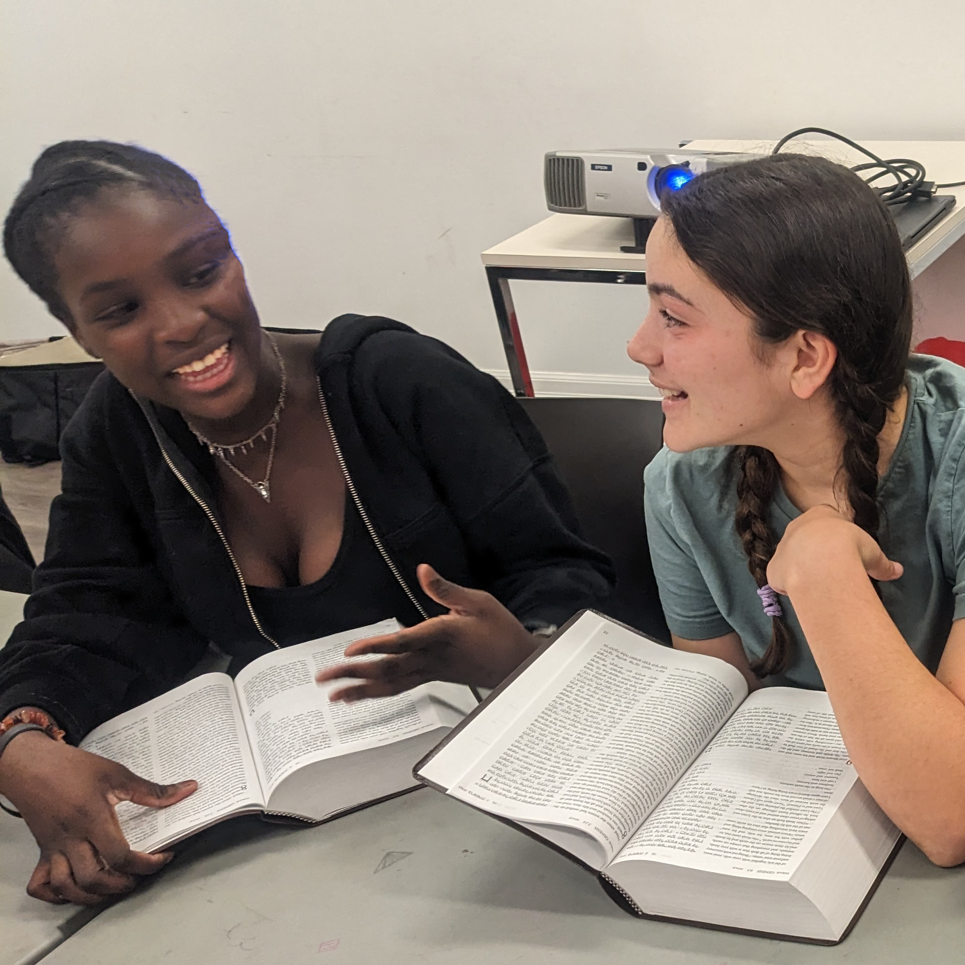 A pair of Makom ATID students with open Tanakhim smiling